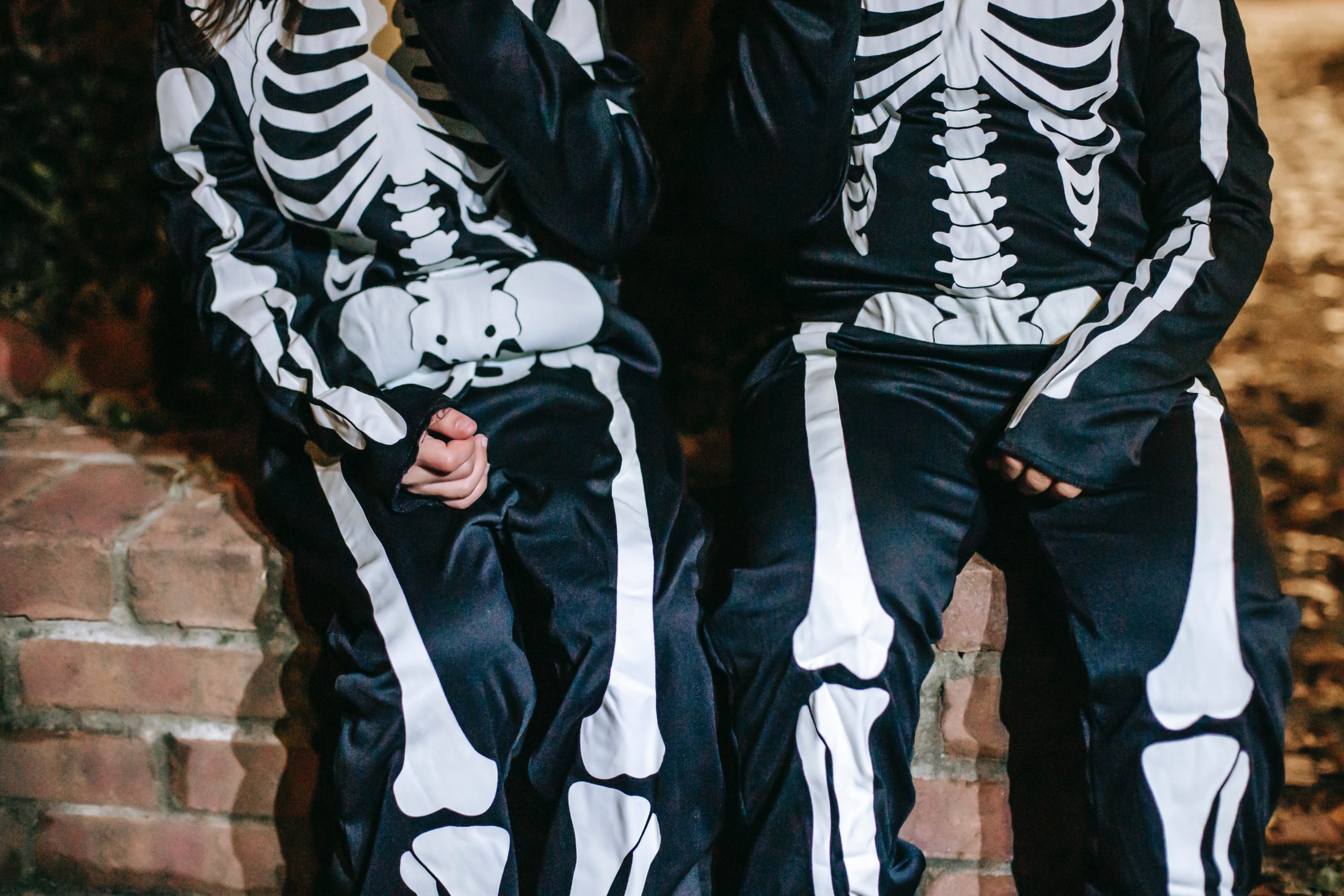 Two children in skeleton costumes